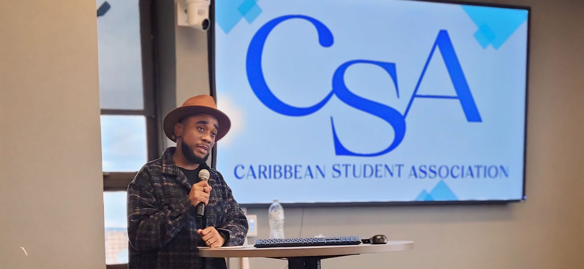 Brian Boyce standing at a podium with the the letters CSA on screen