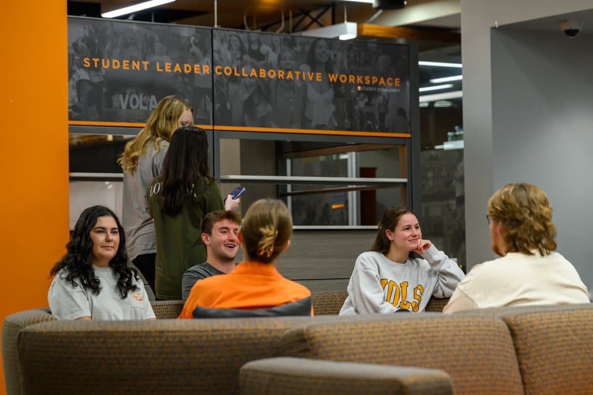 Students sitting down in the Student Union having a conversation.