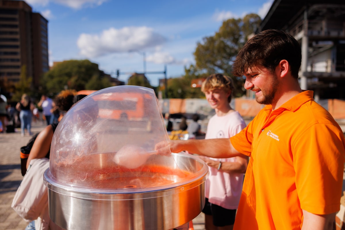 Orange cotton candy is made for attendees of Rocky Top Rally in Circle Park.