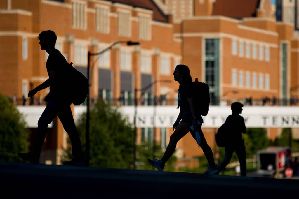 Students walk across Phillip Fulmer Way.