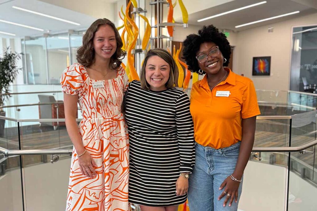 group photo of Vols in Student Affairs Program students and coordinator Valkovschi (left) and Robinson (right) with program administrator Hope Adkins (center). 