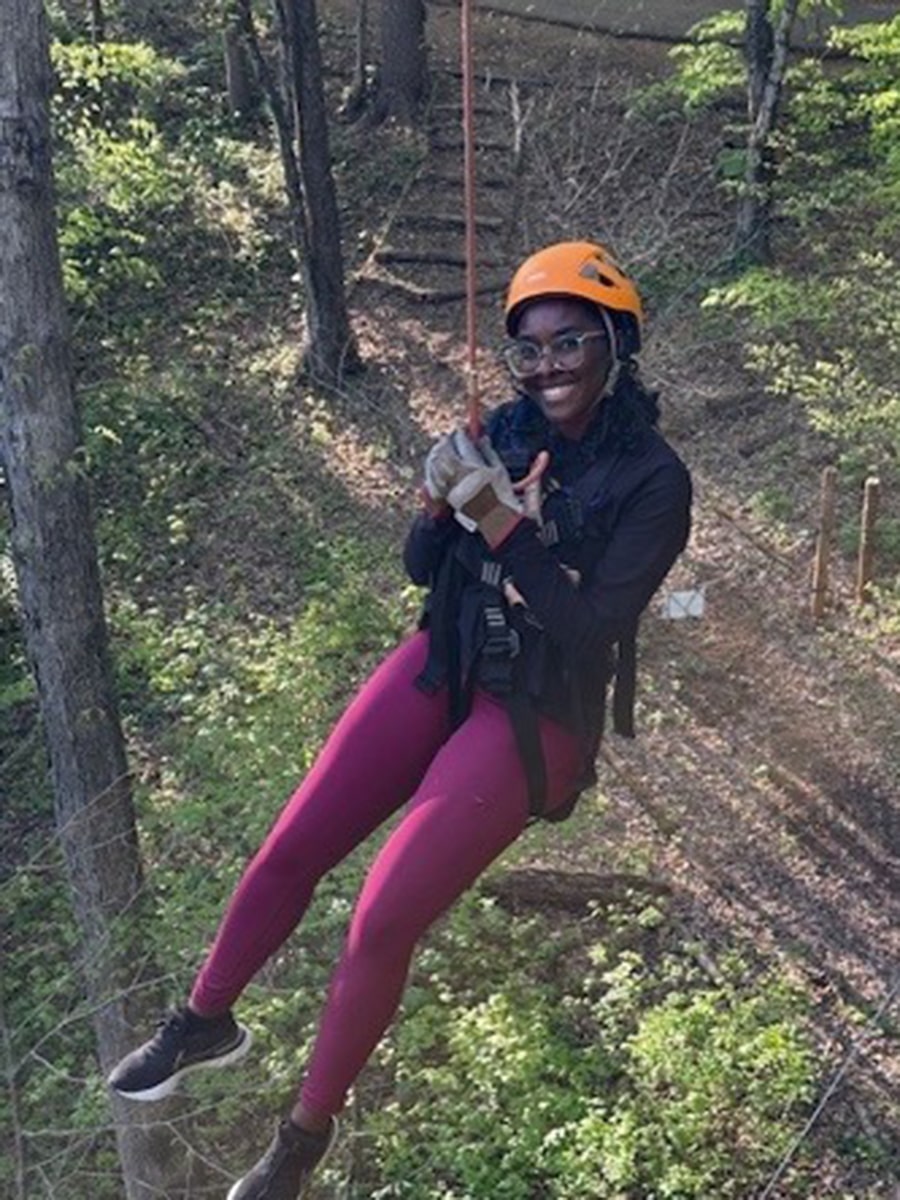 a person scaling a mountain in the woods