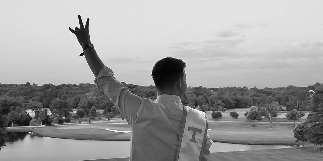Drew holds up the word Vol with his hand.